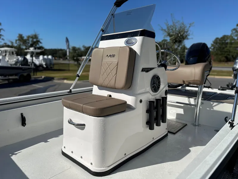Slide: The Image of 2025 Avid 18 Rogue boat interior with tan seating and steering console. - 19