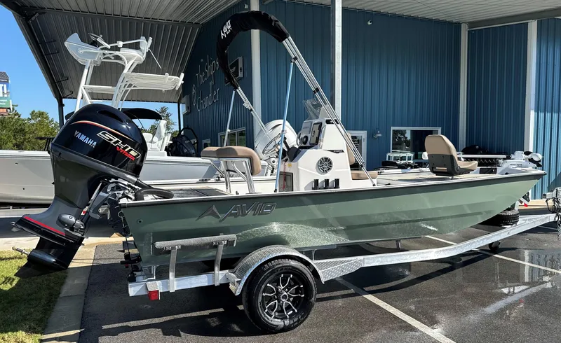 Slide: The Image of Avid 18 Rogue 2025 boat with Yamaha motor on trailer in showroom. - 8
