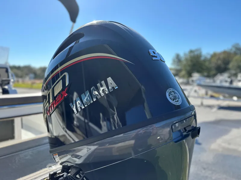 Slide: The Image of Yamaha outboard motor on Avid 18 Rogue 2025 boat, sunny day at marina. - 9