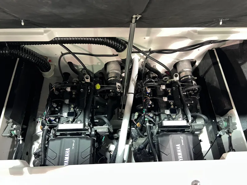 Slide: The Image of 2025 Yamaha AR220 boat engine compartment with dual engines and wiring. - 9