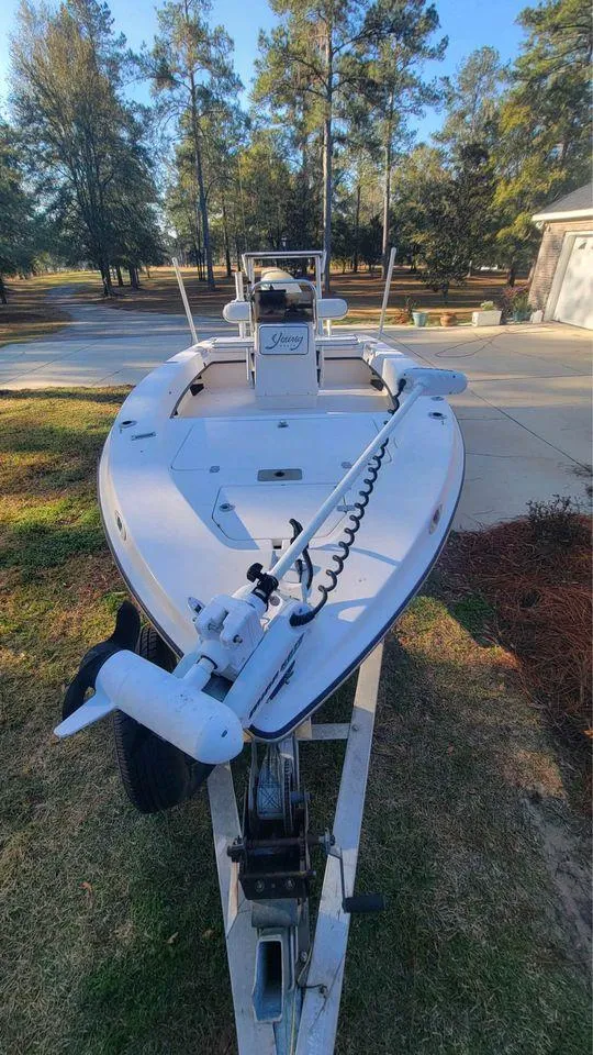 Slide: The Image of 2005 Young Boats 20 on trailer, parked outdoors with trees in background. - 6