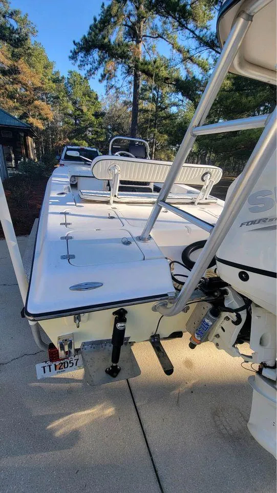 Slide: The Image of 2005 Young Boats 20 model on trailer, surrounded by trees. - 7