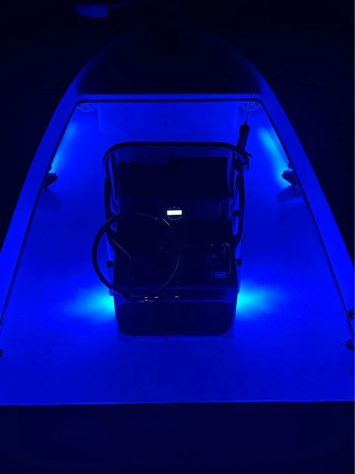 Slide: The Image of 2005 Young Boats 20 with blue LED interior lighting at night. - 8