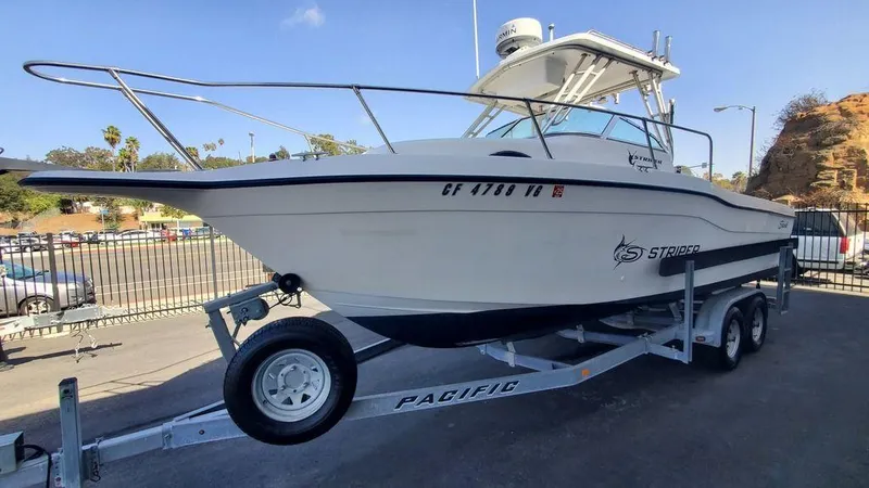 Slide: The Image of 1999 Seaswirl Striper 2600wa boat on trailer in parking lot. - 1