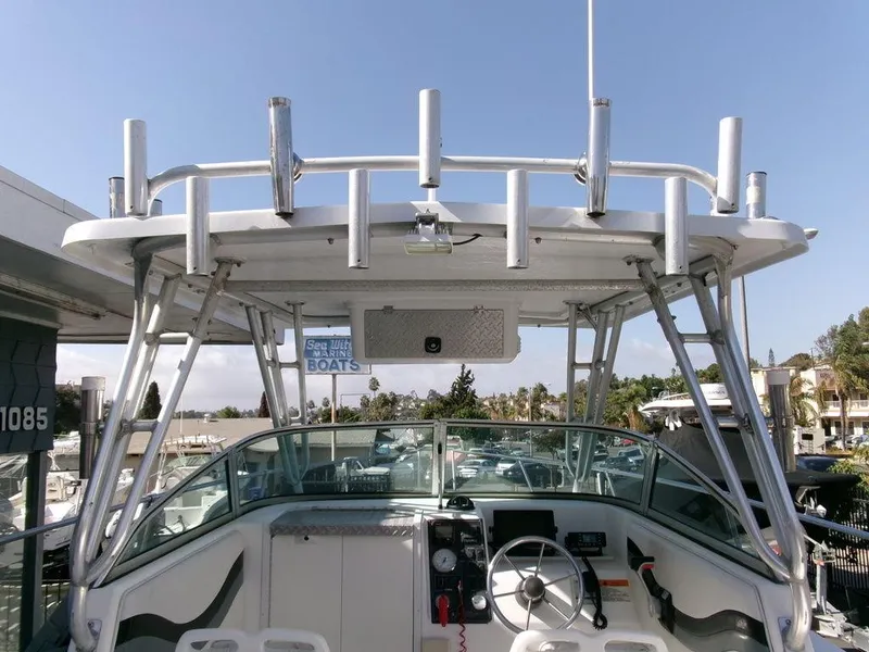 Slide: The Image of 1999 Seaswirl Striper 2600wa boat cockpit with steering wheel and rod holders. - 15
