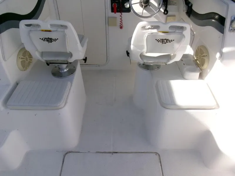 Slide: The Image of 1999 Seaswirl Striper 2600wa boat interior with dual seats and steering wheel. - 17