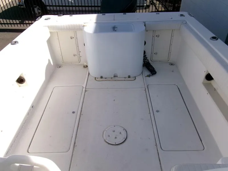 Slide: The Image of 1999 Seaswirl Striper 2600wa boat interior, spacious deck with storage compartments. - 21