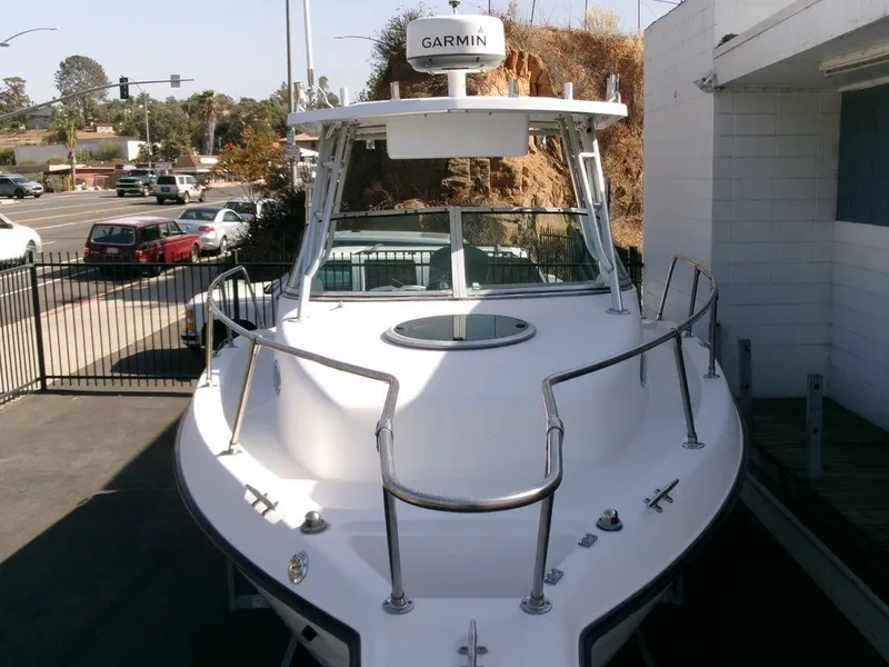 Slide: The Image of 1999 Seaswirl Striper 2600wa boat with Garmin radar, docked near a street. - 27