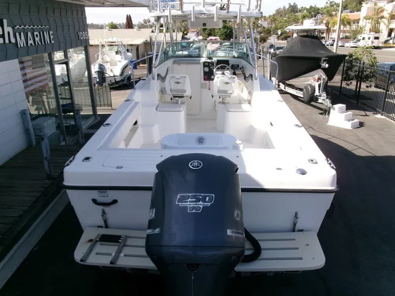 Slide: The Image of 1999 Seaswirl Striper 2600wa boat with Yamaha 250 HP engine, docked at a marina. - 28