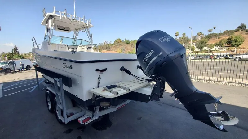 Slide: The Image of 1999 Seaswirl Striper 2600wa boat with Yamaha outboard motor on trailer. - 3