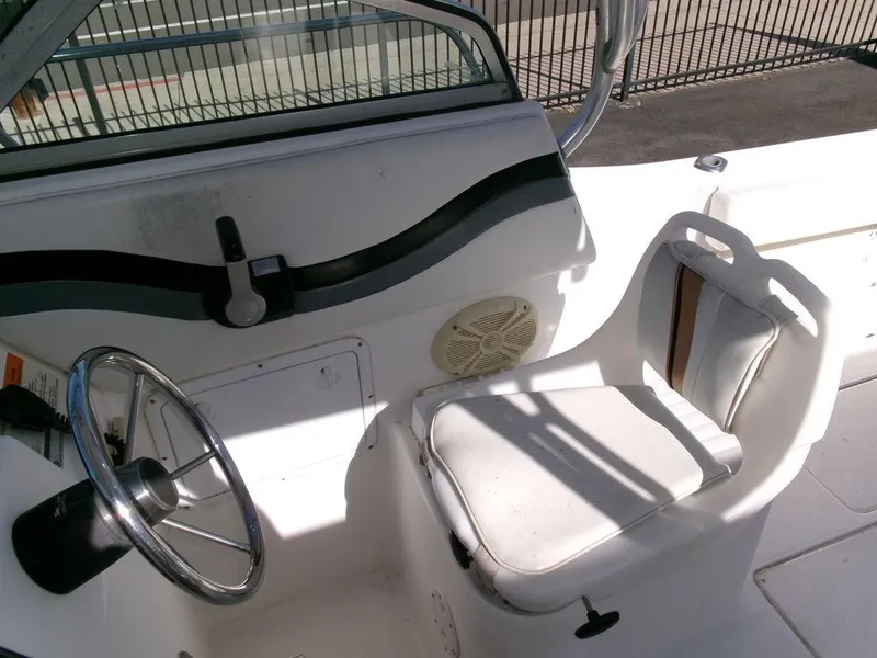 Slide: The Image of 1999 Seaswirl Striper 2600wa boat cockpit with steering wheel and seat. - 8