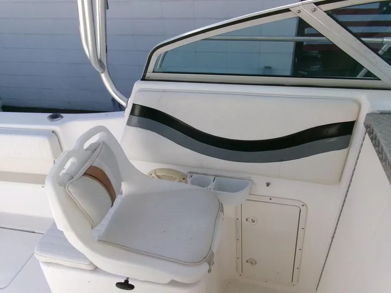 Slide: The Image of 1999 Seaswirl Striper 2600wa boat interior with white seating and storage compartment. - 9