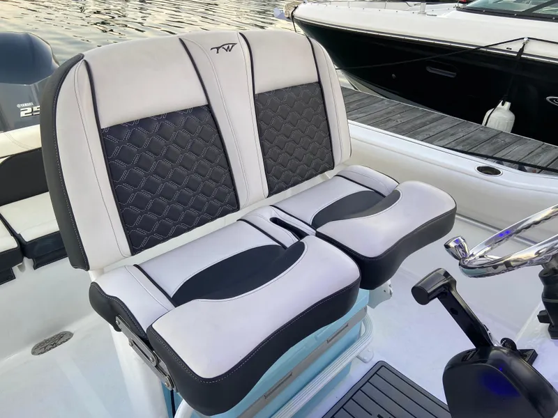 Slide: The Image of 2022 Tidewater 232 LXF boat seats, featuring stylish black and white upholstery. - 8
