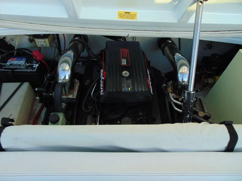 Slide: The Image of 1995 Baja 272 boat engine compartment with visible components and wiring. - 13