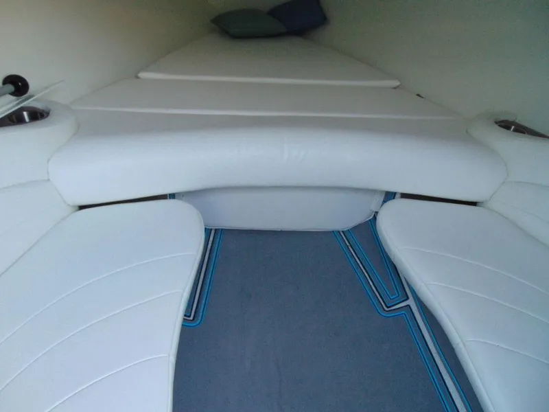 Slide: The Image of Interior of a 1995 Baja 272 boat with white cushioned seating. - 15