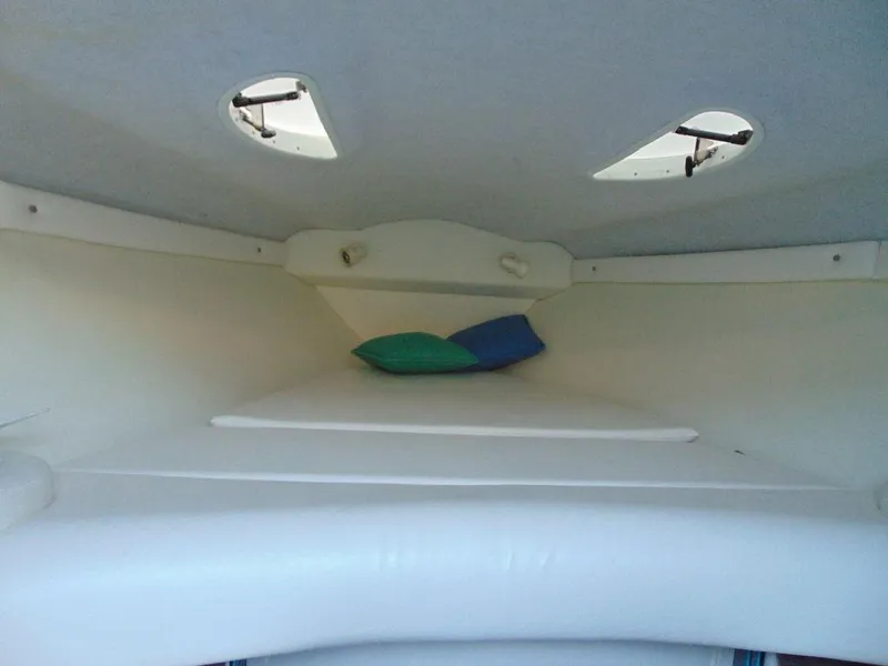 Slide: The Image of Interior cabin of 1995 Baja 272 boat with cushions and portholes. - 16