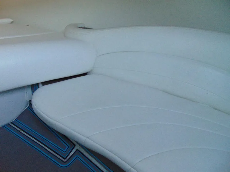 Slide: The Image of 1995 Baja 272 boat interior with white cushioned seating. - 17