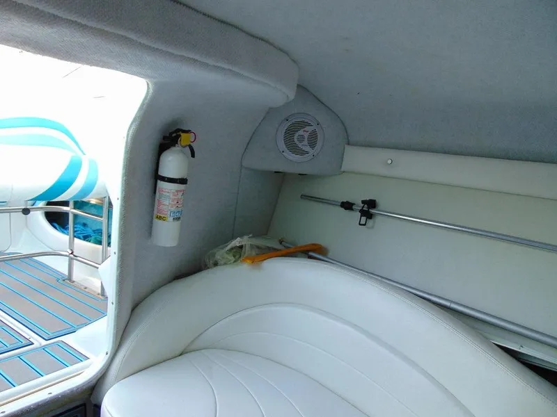Slide: The Image of Interior of a 1995 Baja 272 boat with white seating and safety equipment. - 19