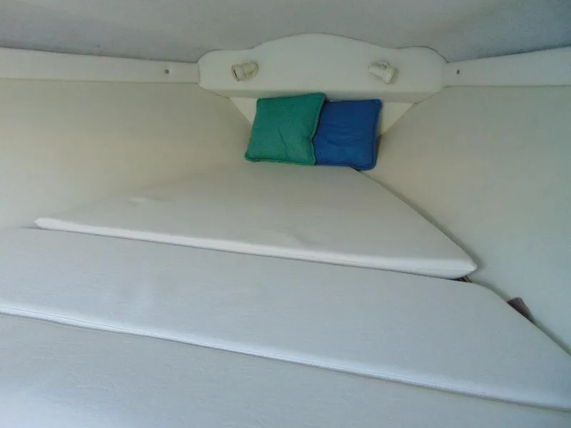 Slide: The Image of Interior cabin of a 1995 Baja 272 boat with cushions and pillows. - 21