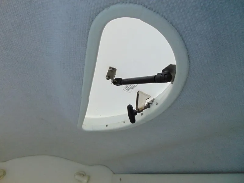 Slide: The Image of 1995 Baja 272 boat hatch interior view with open mechanism. - 22