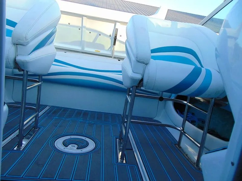Slide: The Image of Interior of a 1995 Baja 272 boat with blue and white seating and flooring. - 23