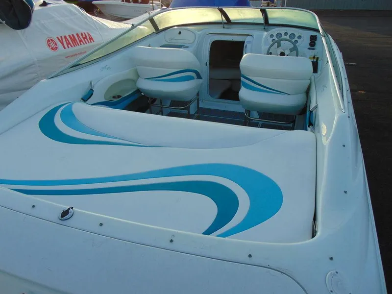 Slide: The Image of 1995 Baja 272 boat interior with blue and white seating design. - 6