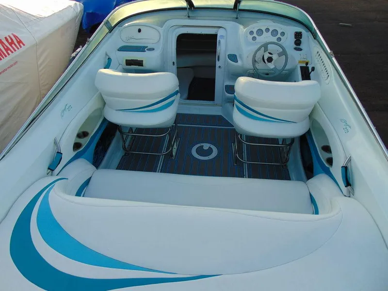 Slide: The Image of 1995 Baja 272 boat interior with white and blue seating and dashboard. - 7