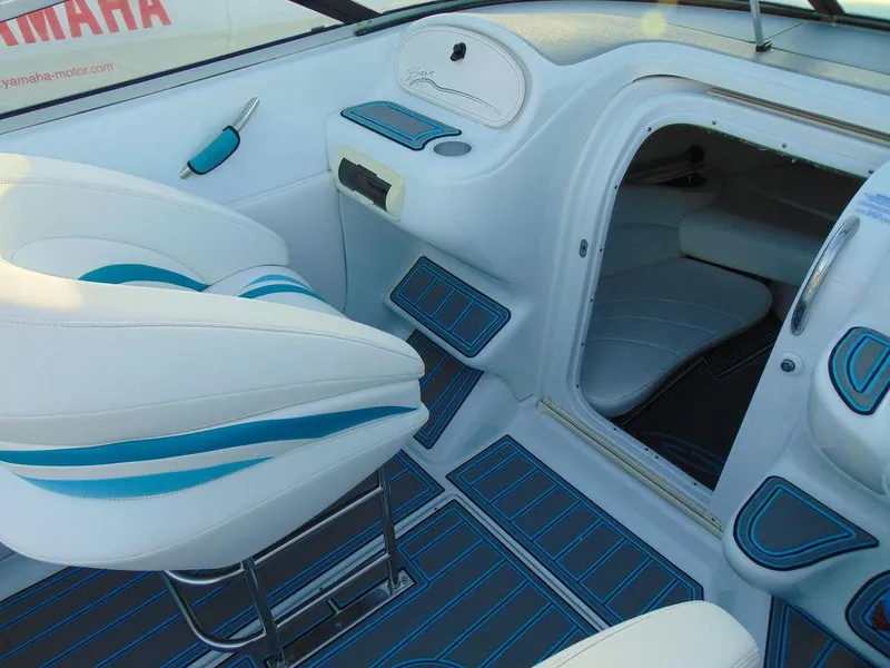 Slide: The Image of Interior of a 1995 Baja 272 boat with white and blue seating and flooring. - 9