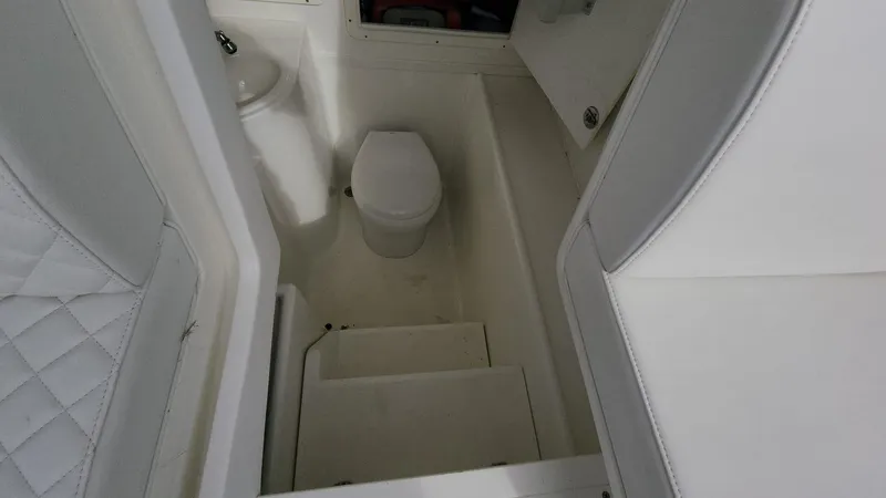 Slide: The Image of 2017 SeaVee 390Z boat interior bathroom with toilet and sink. - 11