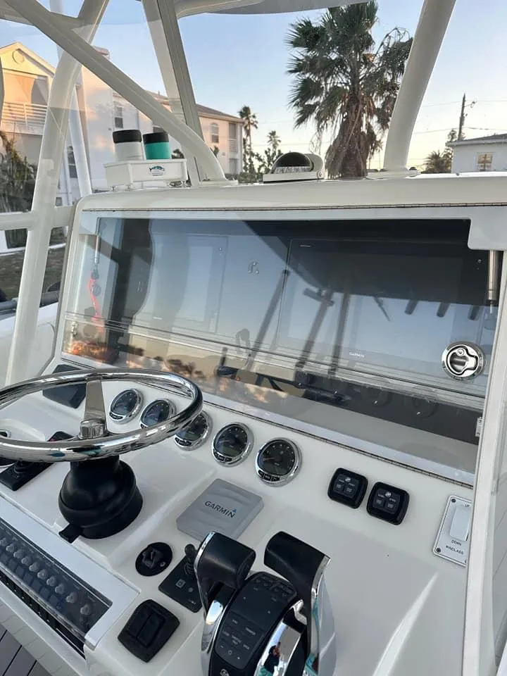 Slide: The Image of 2017 SeaVee 390Z boat dashboard with steering wheel and controls. - 12