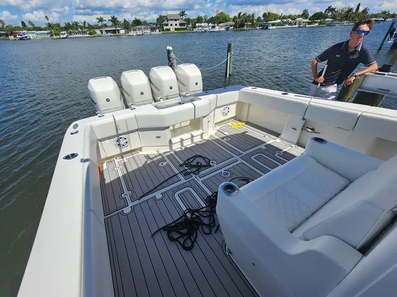 Slide: The Image of 2017 SeaVee 390Z boat with spacious deck and quad engines docked by the water. - 14