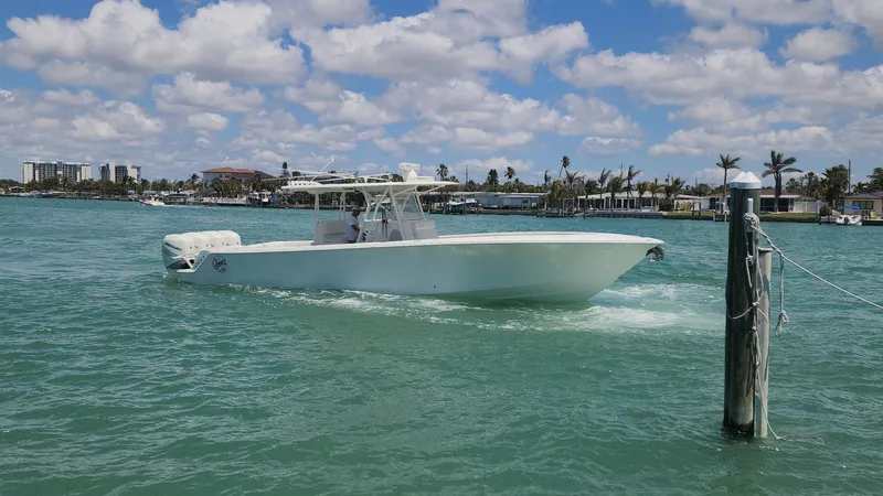 Slide: The Image of 2017 SeaVee 390Z boat cruising on turquoise water under a partly cloudy sky. - 3