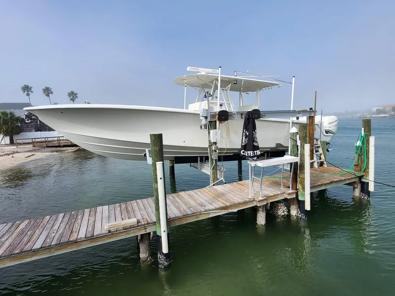 Slide: The Image of 2017 SeaVee 390Z boat docked on a lift by the water. - 5