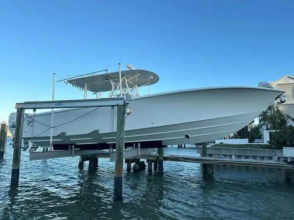 Slide: The Image of 2017 SeaVee 390Z boat on lift, docked by waterfront home. - 6