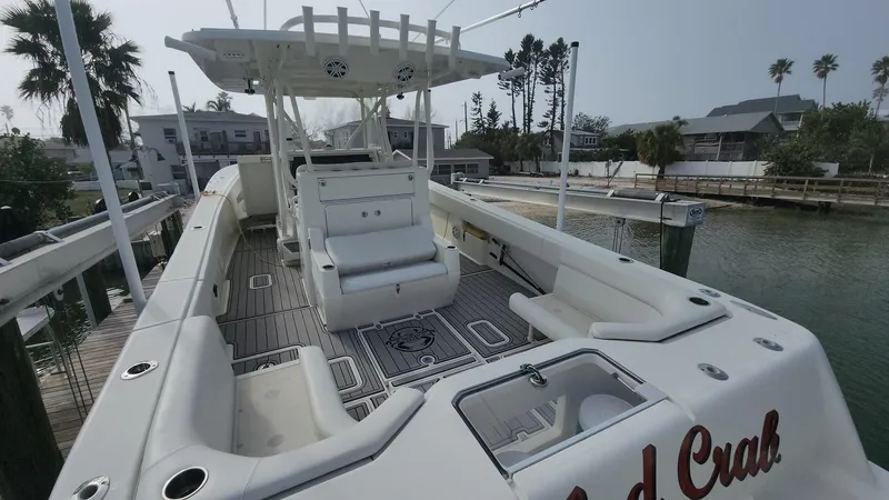 Slide: The Image of 2017 SeaVee 390Z boat with spacious deck and seating, docked by waterfront homes. - 7