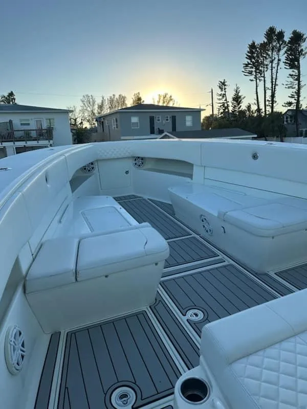 Slide: The Image of 2017 SeaVee 390Z boat interior with cushioned seating and sleek design at sunset. - 9