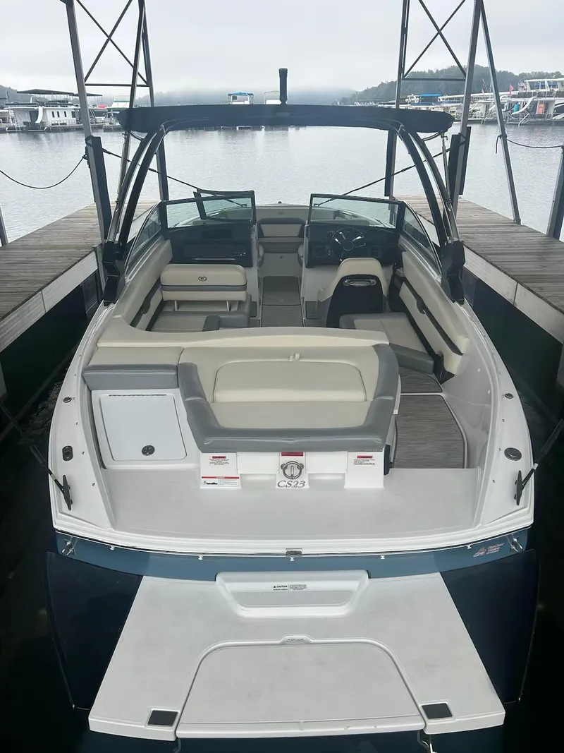 Slide: The Image of 2021 Cobalt CS23 boat docked, featuring spacious seating and sleek design. - 13