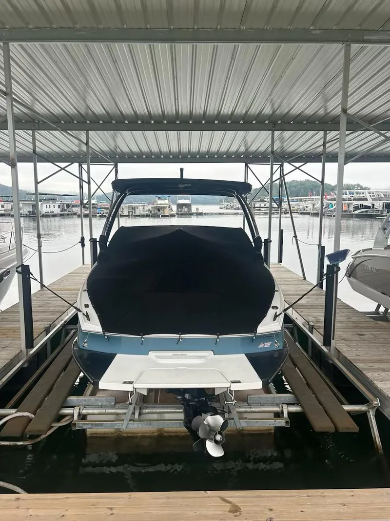 Slide: The Image of 2021 Cobalt CS23 boat docked under a covered marina. - 3
