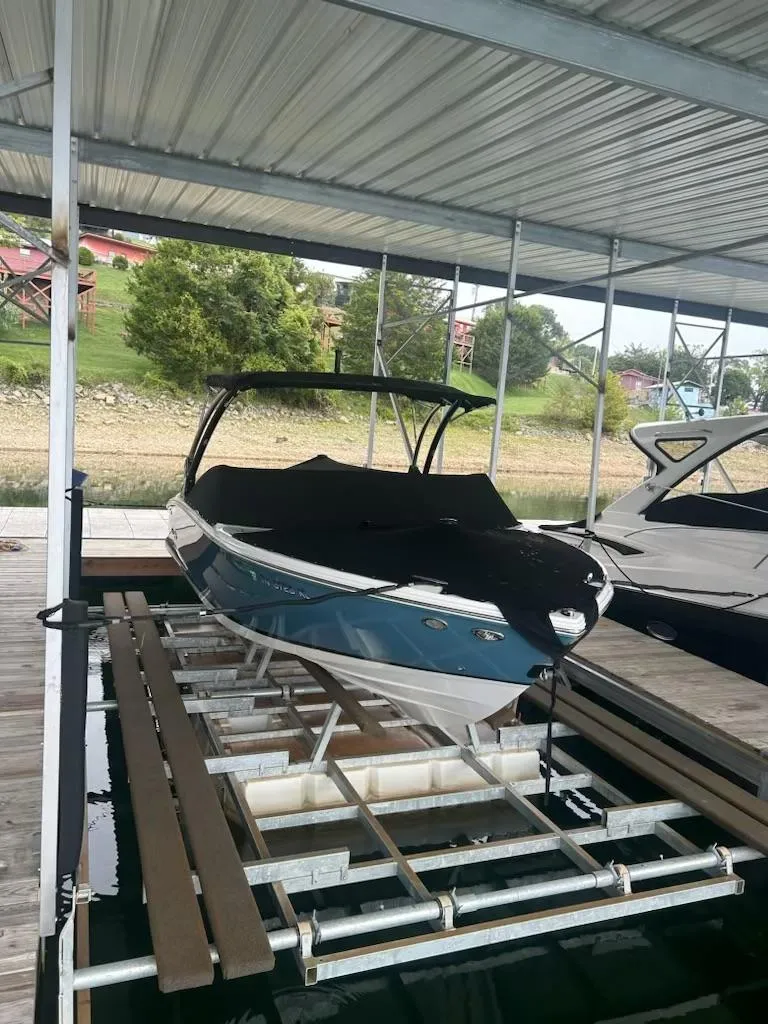 Slide: The Image of 2021 Cobalt CS23 boat docked under a covered marina. - 4
