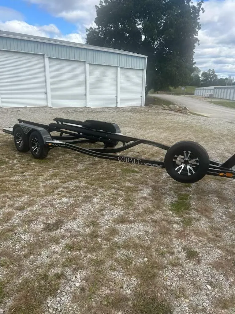 Slide: The Image of 2021 Cobalt CS23 boat trailer parked on gravel near storage units. - 7