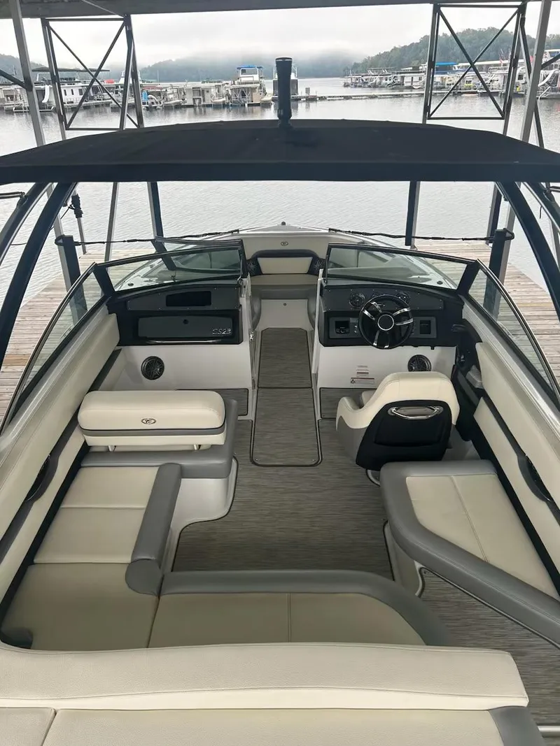 Slide: The Image of 2021 Cobalt CS23 boat interior with sleek seating and modern dashboard. - 8