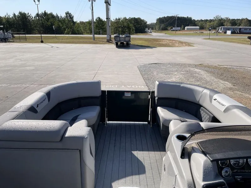 Slide: The Image of 2025 Starcraft SLS-3 pontoon boat interior with gray seating and open deck view. - 10