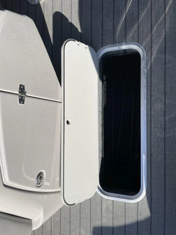 Slide: The Image of Starcraft SLS-3 2025 boat storage compartment with open hatch on deck. - 19