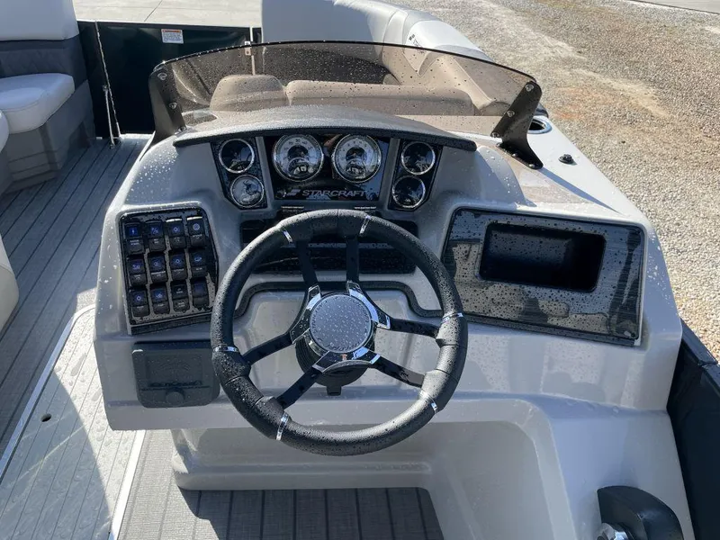 Slide: The Image of 2025 Starcraft SLS-3 boat dashboard with steering wheel and control panel. - 6