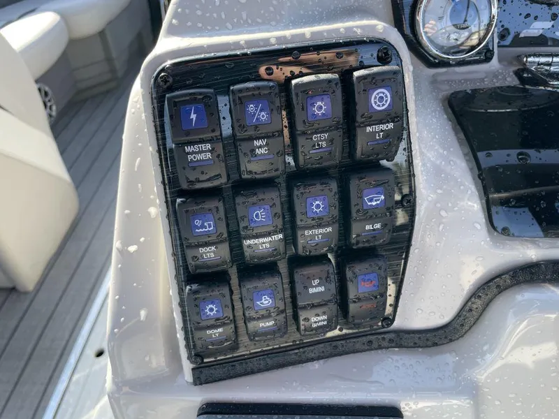 Slide: The Image of Control panel of a 2025 Starcraft SLS-3 boat with various switches. - 8