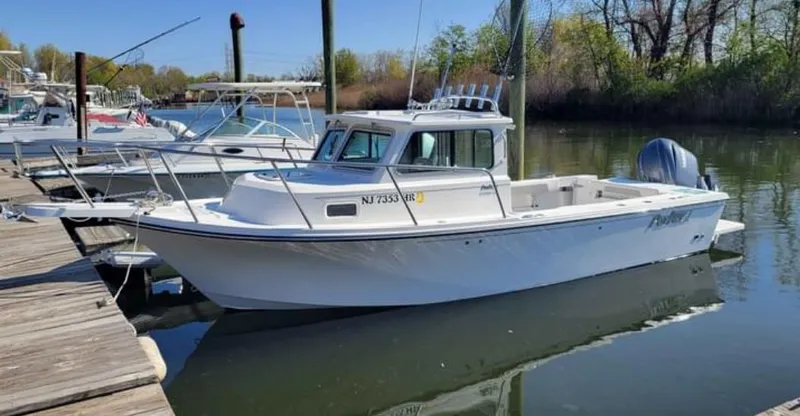 The Image of 2022 Parker 2320 SL Sport Cabin boat docked in a marina. - 0