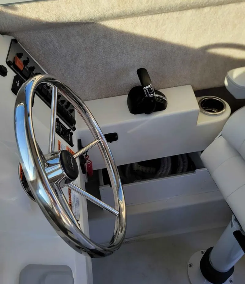 Slide: The Image of 2022 Parker 2320 SL Sport Cabin boat steering wheel and controls. - 11