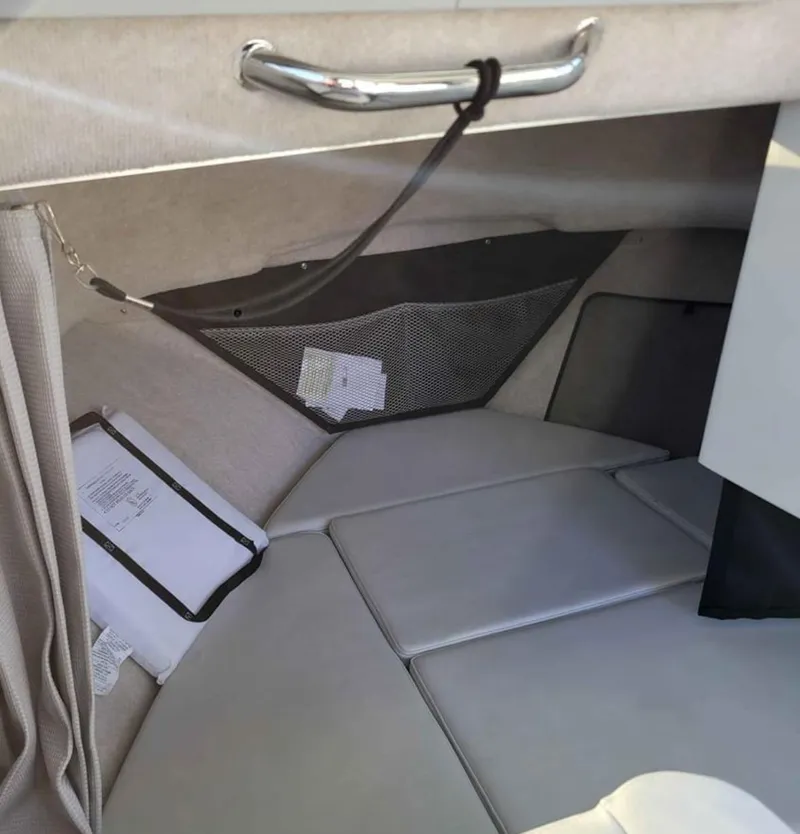 Slide: The Image of 2022 Parker 2320 SL Sport Cabin interior with cushioned seating and storage net. - 12