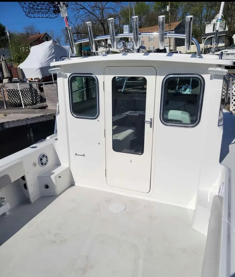 Slide: The Image of 2022 Parker 2320 SL Sport Cabin boat with spacious deck and cabin entry. - 3