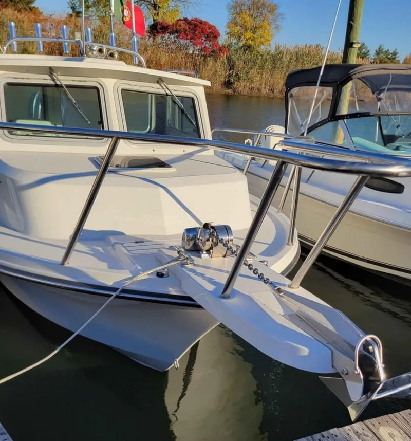 Slide: The Image of 2022 Parker 2320 SL Sport Cabin boat docked in a marina. - 7